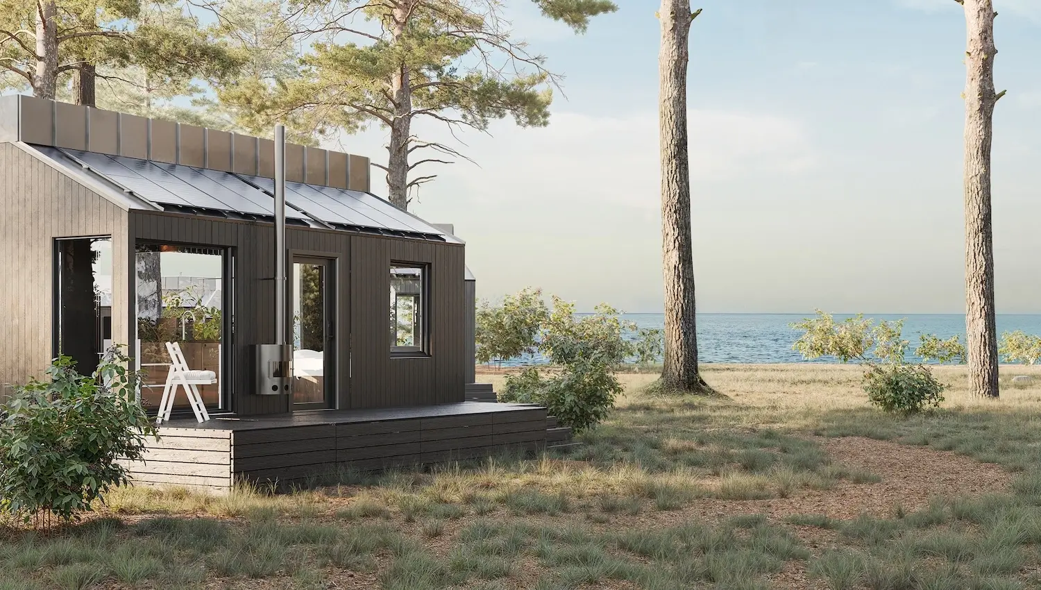 Modern modular home by the water with solar panels and dark wood exterior