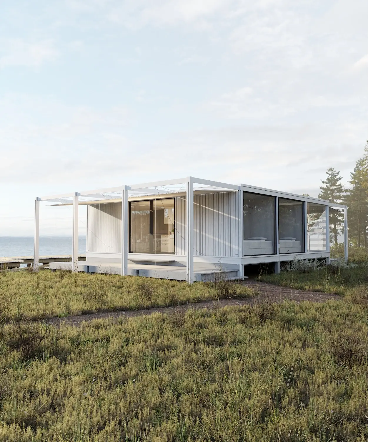 White modular house with panoramic glazing on a coastal site