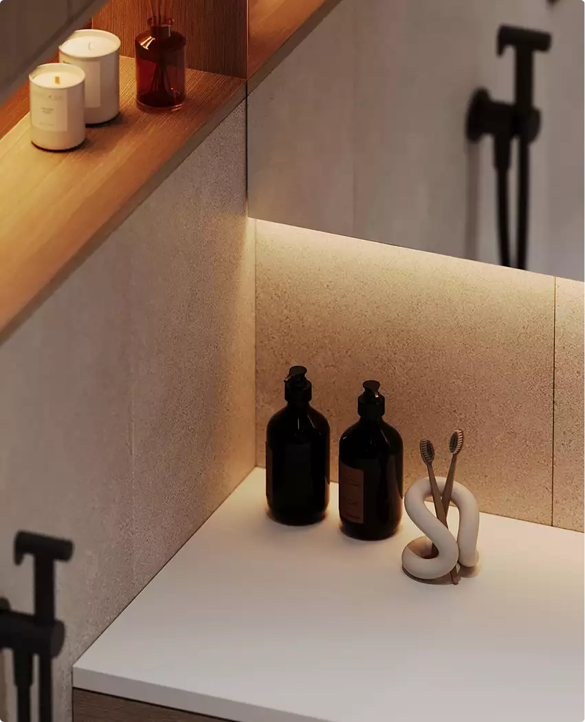 Bathroom counter with bottles and toothbrush holder under warm light, black apartment design