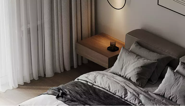 Bedroom corner with bed, pillows and bedside table near curtains, black apartment design