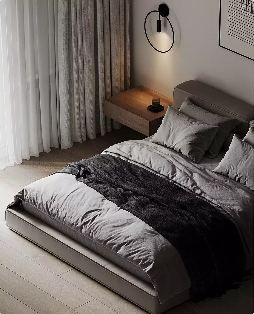 Bedroom with low bed, soft bedding and wall light near curtains, black apartment design
