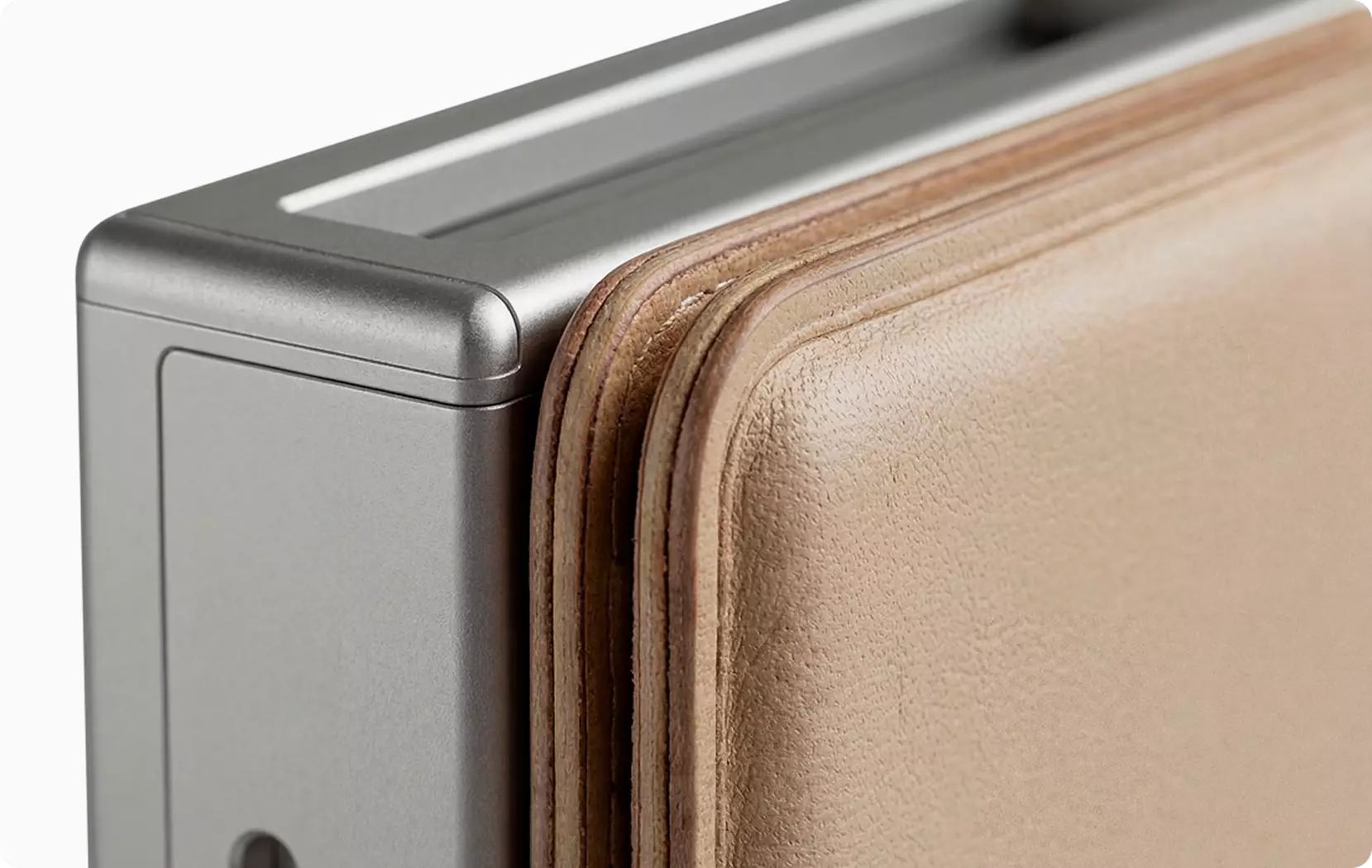 Close up of suitcase corner with metal frame and leather edge detail studio packshots