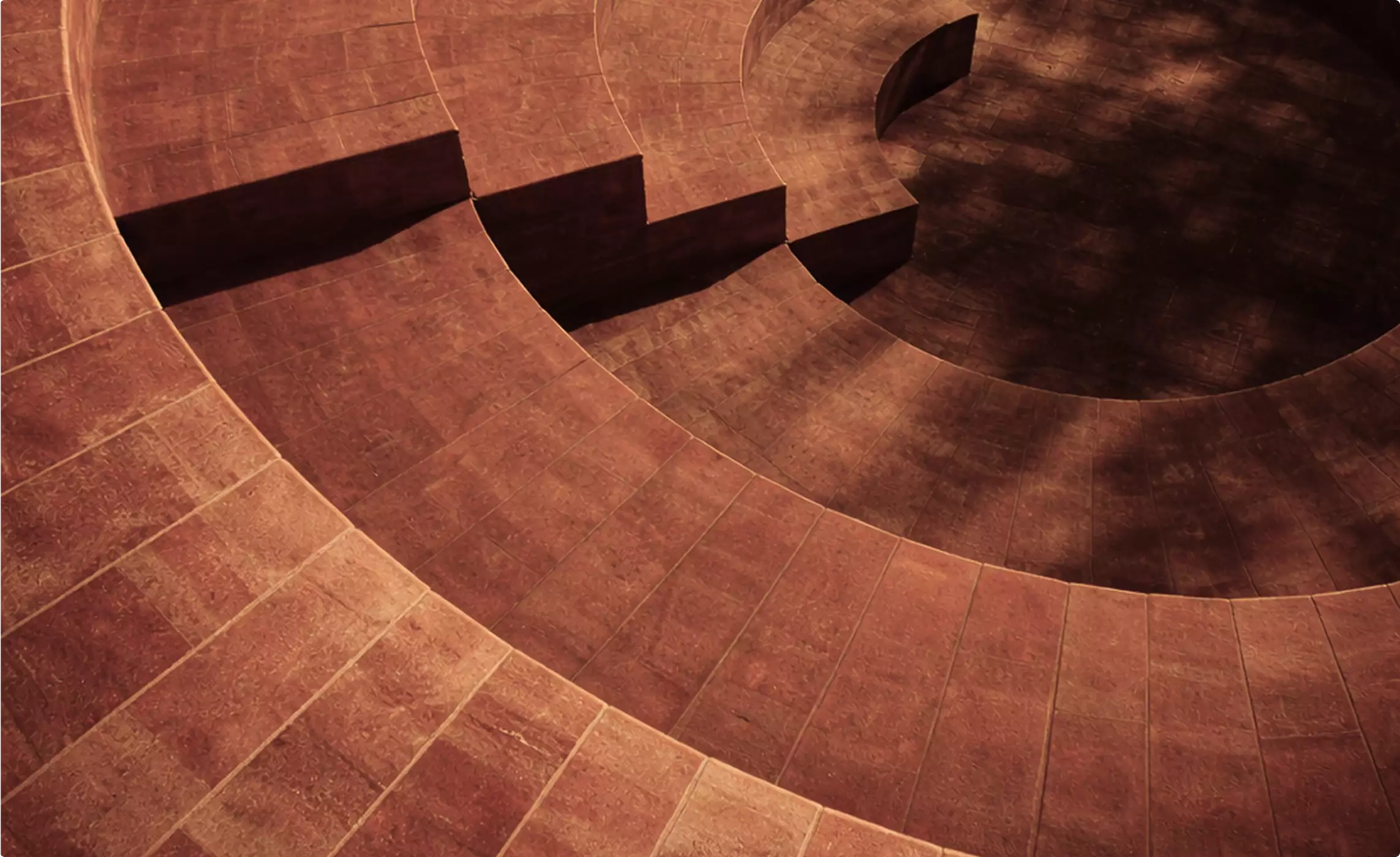 Desert hotel 3D rendering interior courtyard with circular steps and warm light shadows