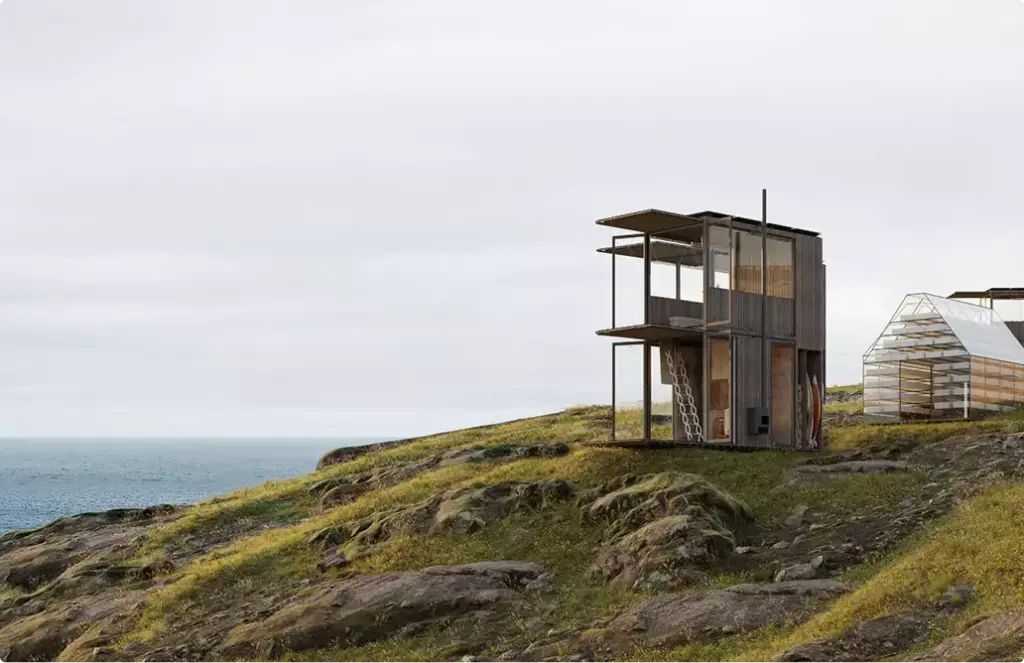 Exterior rendering services for a narrow coastal cabin on a rocky shoreline with sea views