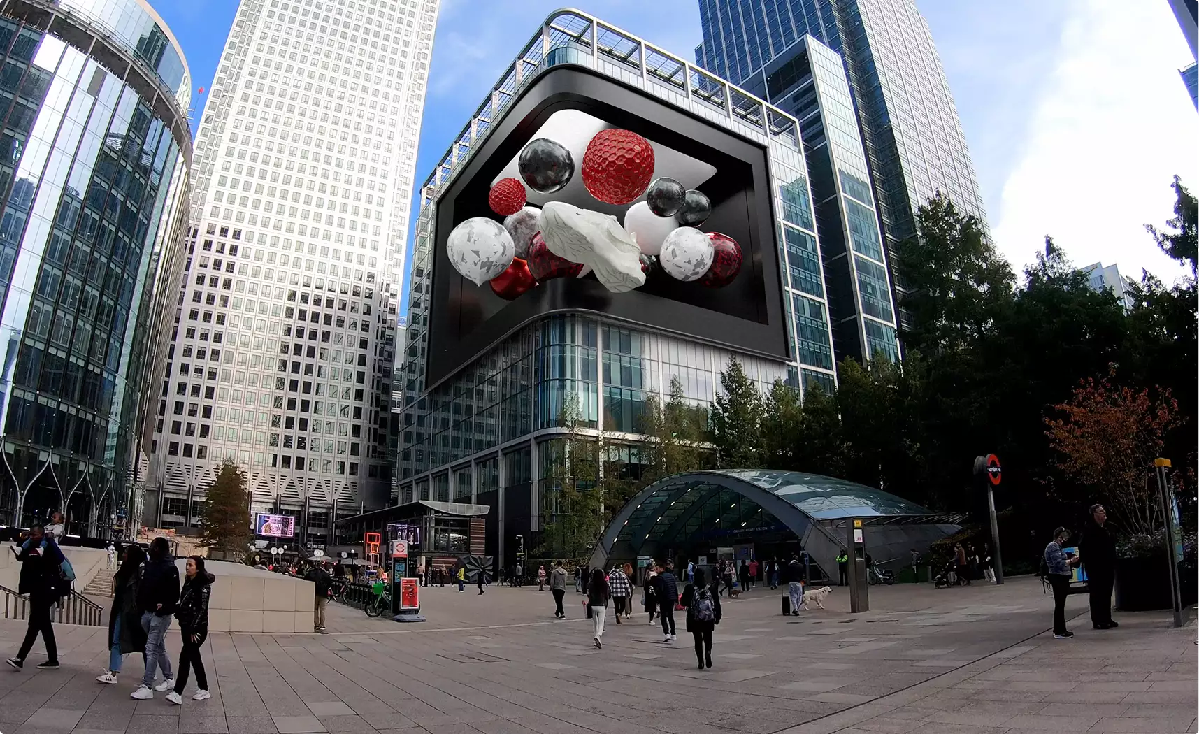 Fooh ads on a giant 3D billboard above a city plaza, with towers, pedestrians, and a station entrance