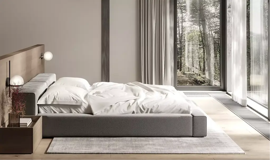 Forest house interior bedroom with low bed, soft bedding, and large window overlooking forest trees
