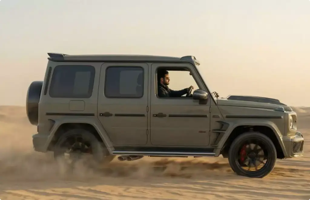 High-end automotive rendering service gray SUV driving across desert sand with driver in profile