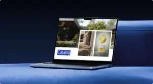 Laptop on surface showing catalog layout with interior and product images, menu pictures display