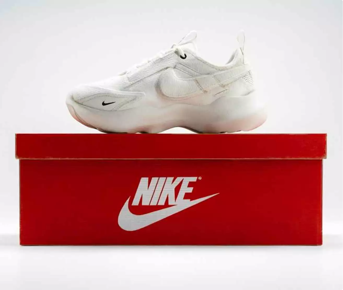 Fooh CGI white sneaker on a red Nike shoebox against a plain light background