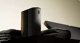 Black speaker on folded fabric Product modeling soft lighting setup