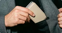 Hand placing wallet in jacket pocket Product modeling close-up detail