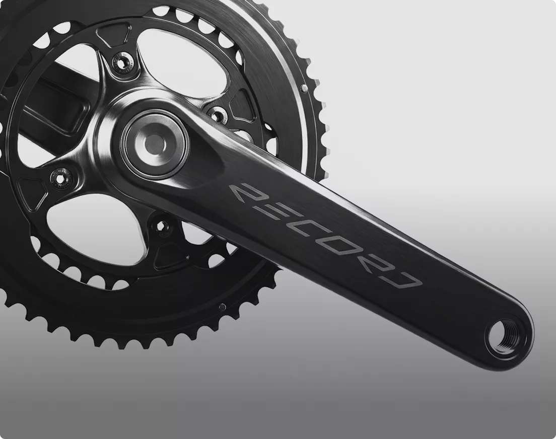 Close-up of metal crankset and chainring, product rendering with clean minimal background