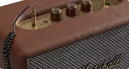 Vintage style speaker with knobs and textured grille, product rendering in warm tones