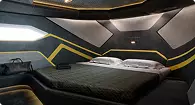Yacht bedroom rendering with modern bed geometric wall panels and ambient lighting design
