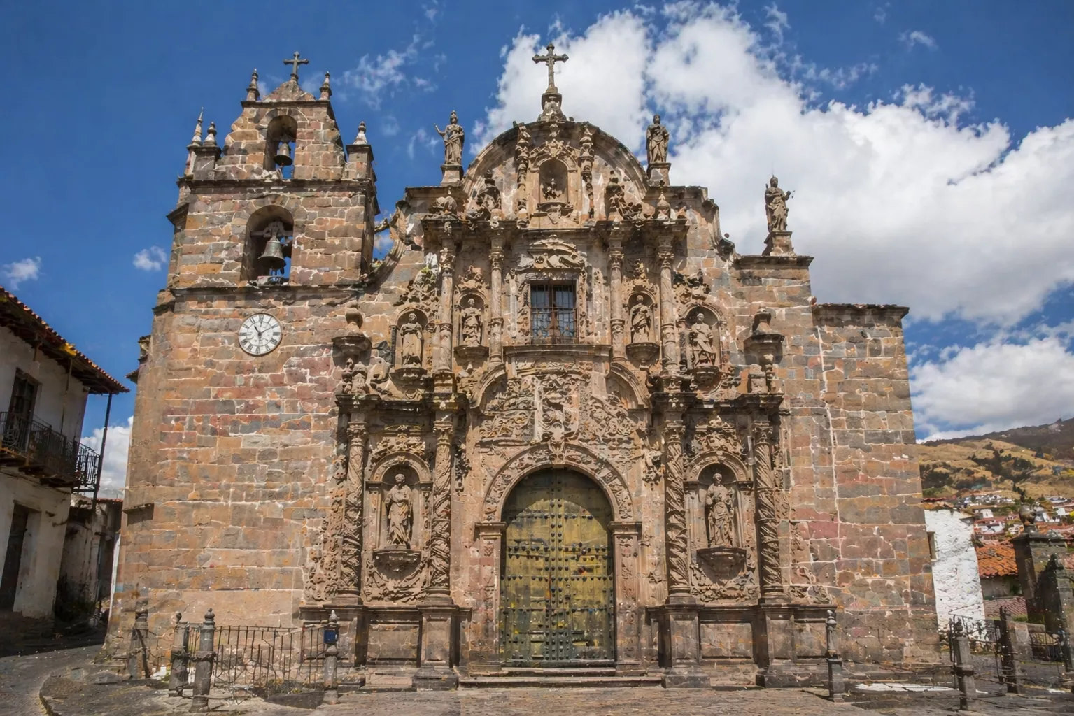 Baroque church facade with ornate carvings and statues under blue sky, Baroque Architecture