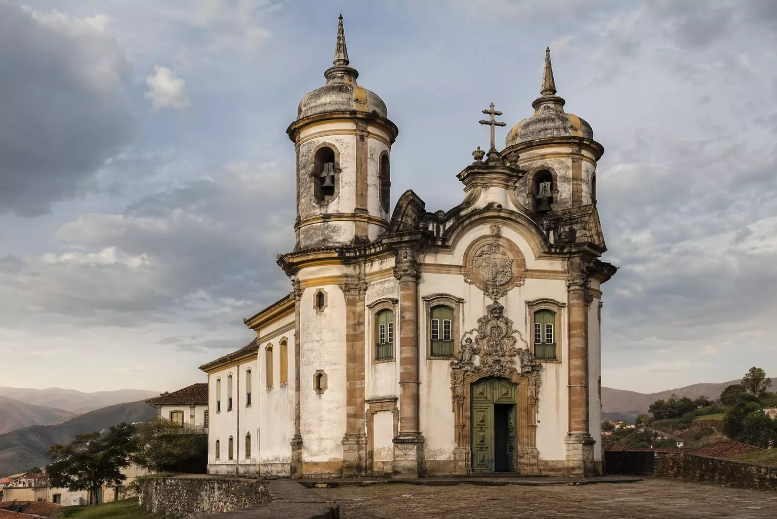 Baroque church with twin bell towers on hill under cloudy sky, Baroque Architecture