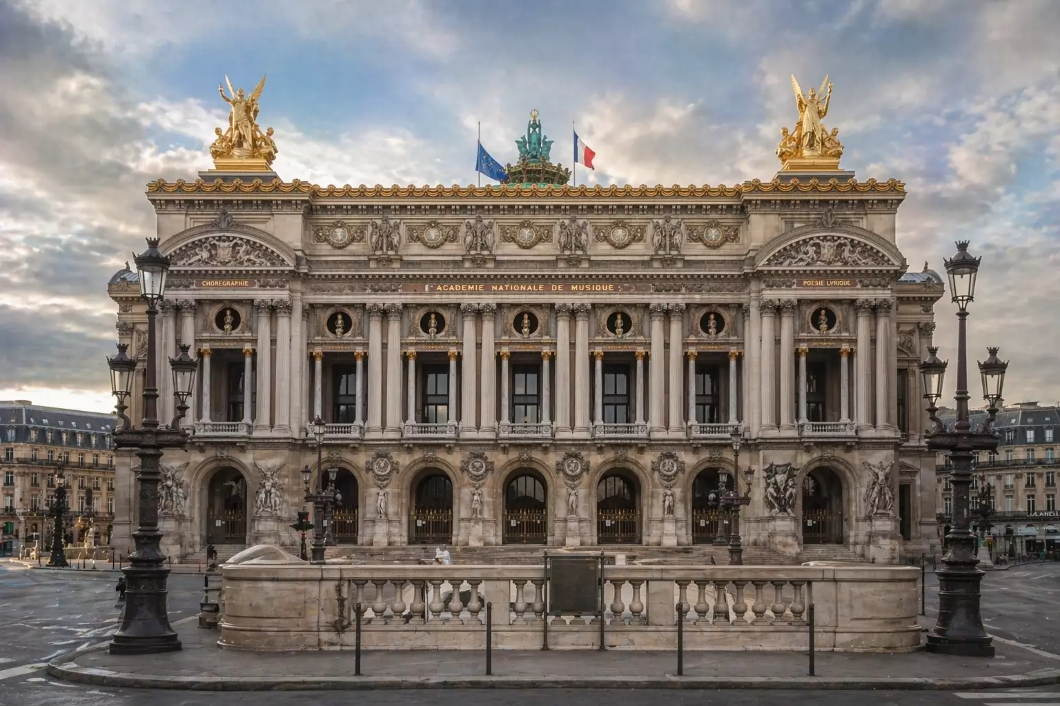 Opera house facade with columns statues and lamps at dusk, Baroque Architecture