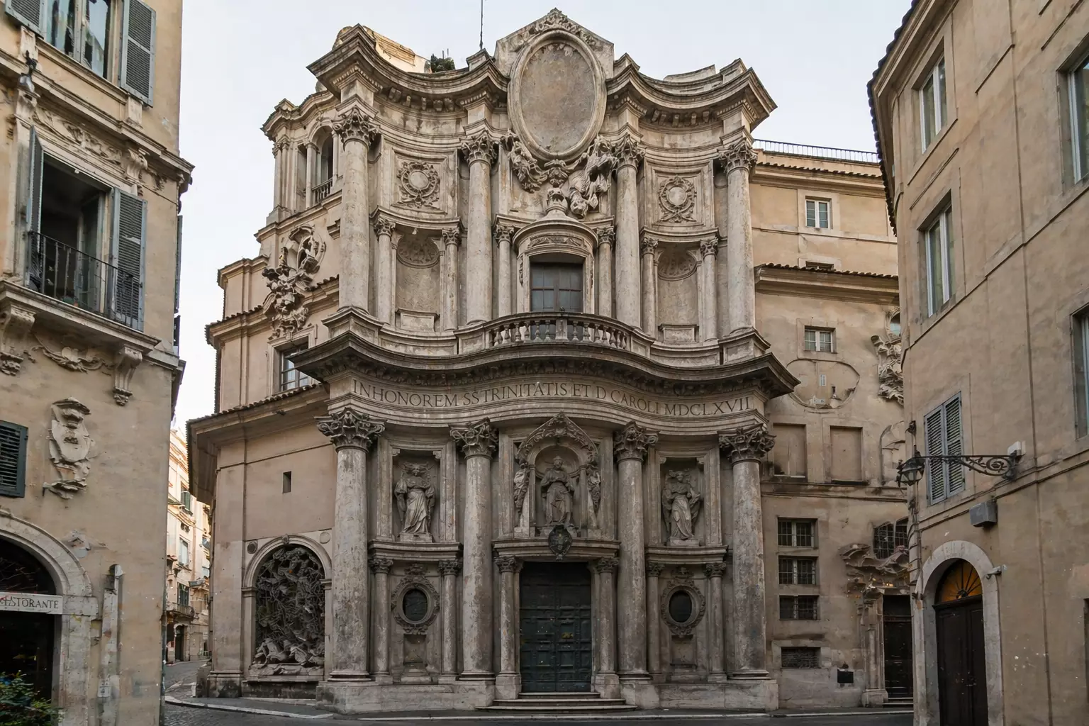 Ornate baroque church facade with columns in narrow street, Baroque Architecture
