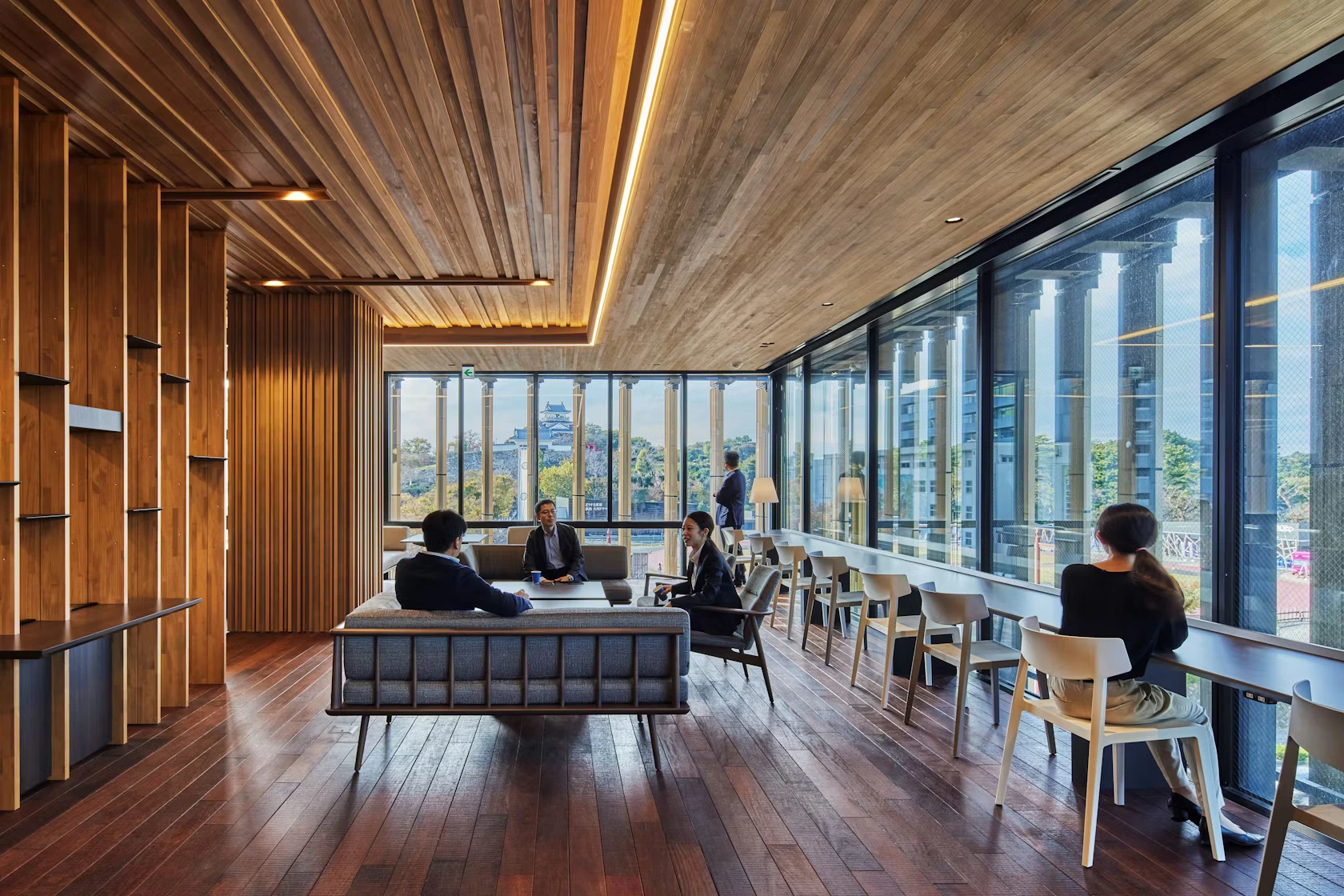 Best 3D Interior Rendering Companies in 2026 Modern office lounge with wood ceiling panels, large windows, and soft seating
