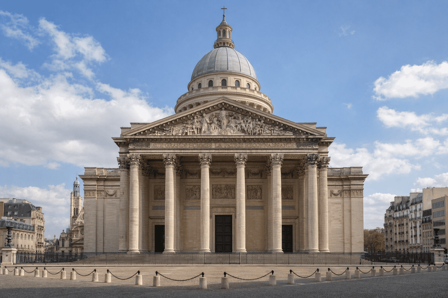 Neoclassical architecture facade with columns and dome under blue sky in Paris