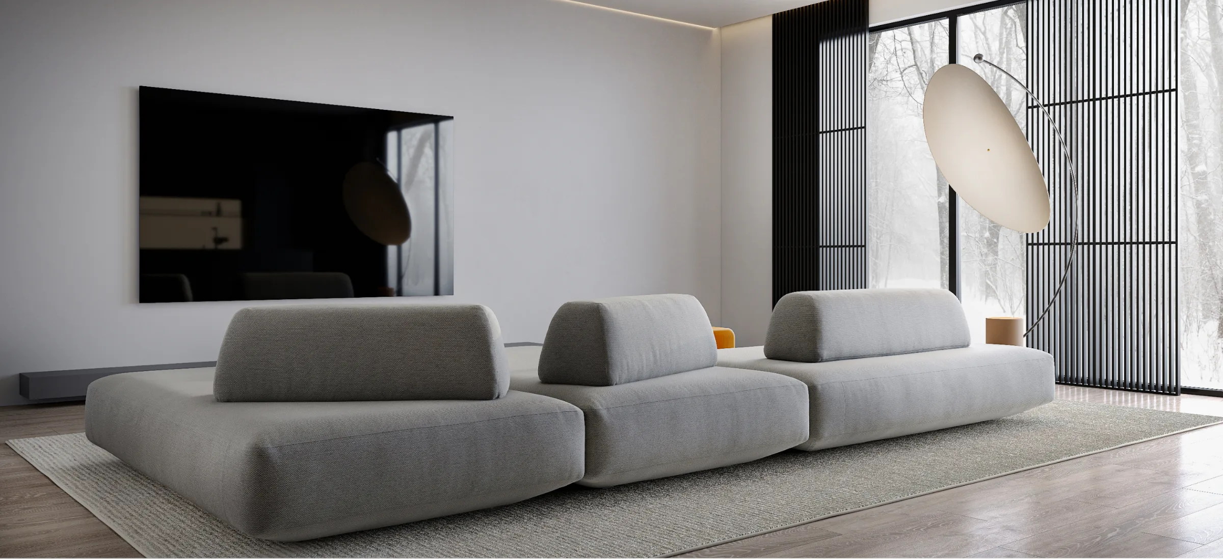 Minimal living room with modular gray sofa, floor lamp, and large window daylight.