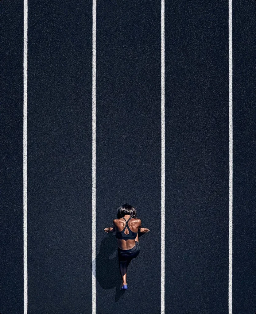 Athlete in a spotlight on a dark court, sports brand world.