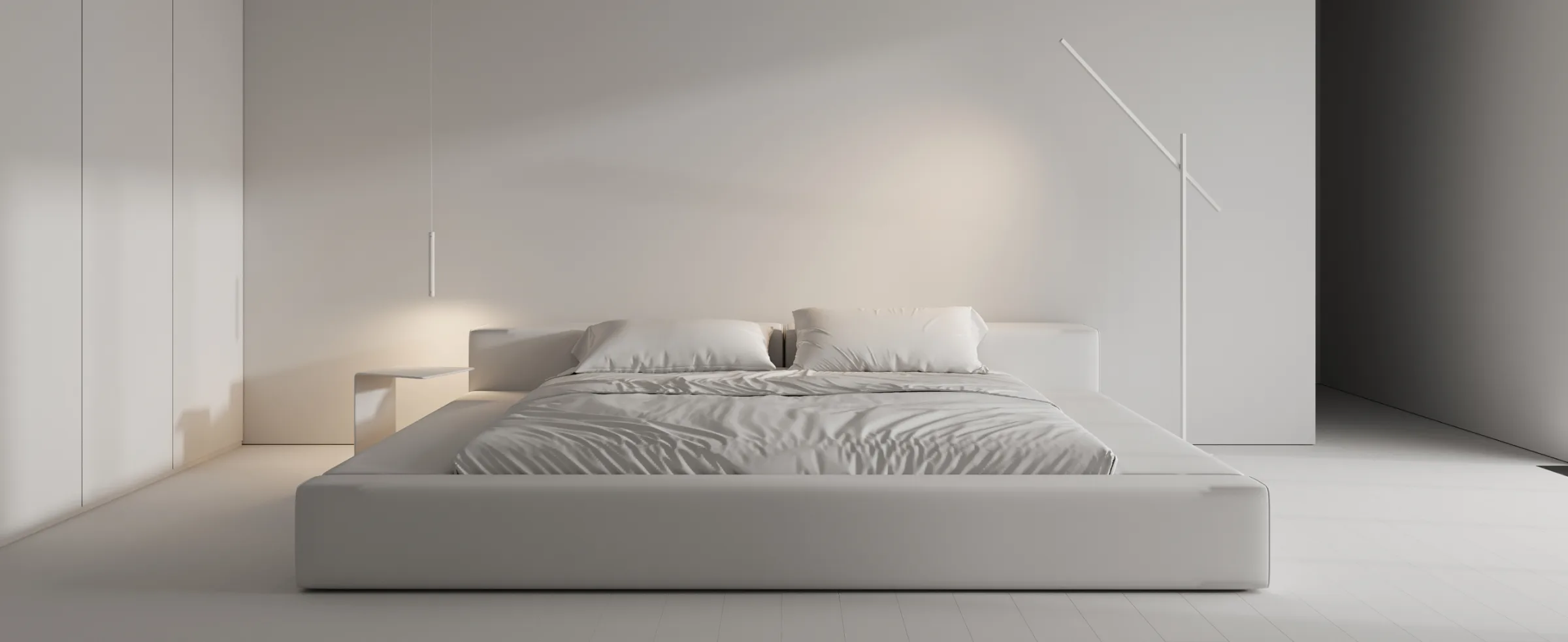 Minimalist bedroom interior with low bed, soft lighting, and neutral color palette.