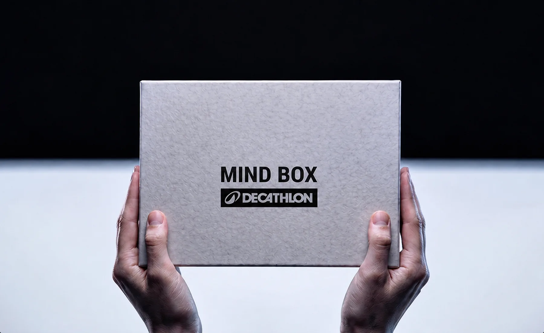 Hands holding a Decathlon Mind Box.