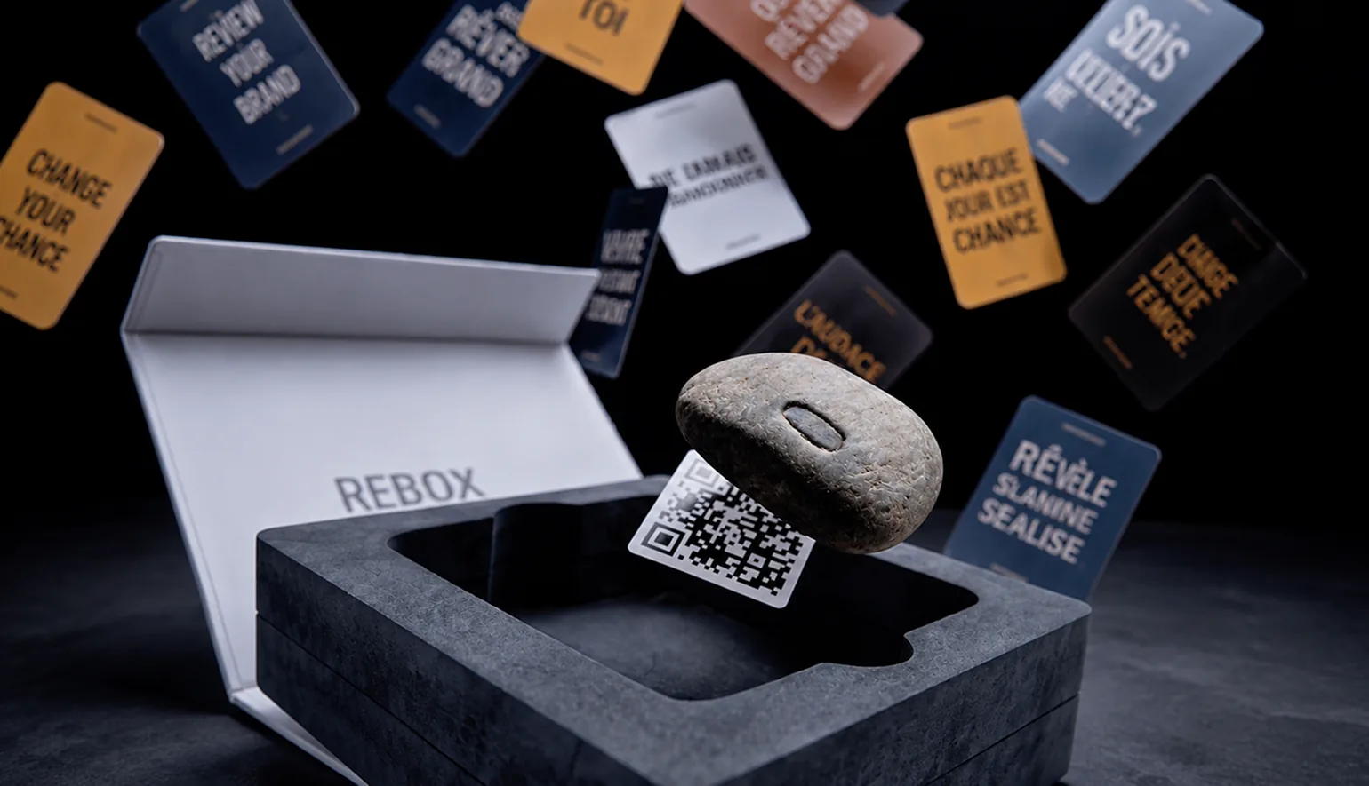 Mind Box motivational cards, engraved stone, and QR code.