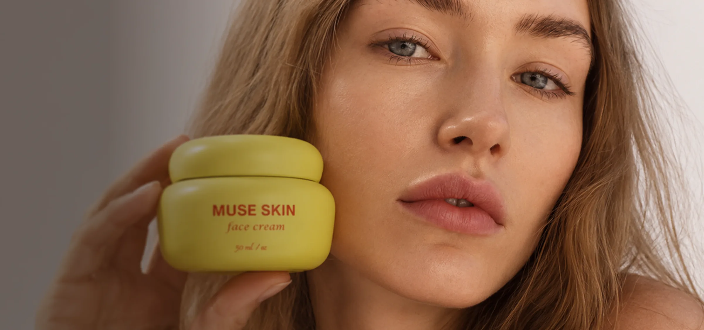 Beauty model with a yellow face-cream jar near her cheek, AI product visualization for a skincare brand.